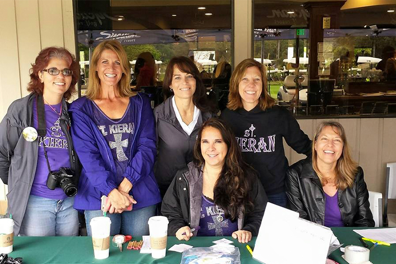 Women working table at golf tournament 