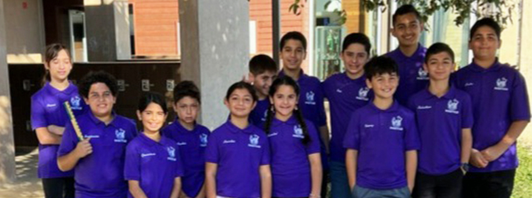 Group of students outside in purple shirts