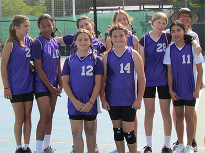 Varsity Girls Volleyball team posing together
